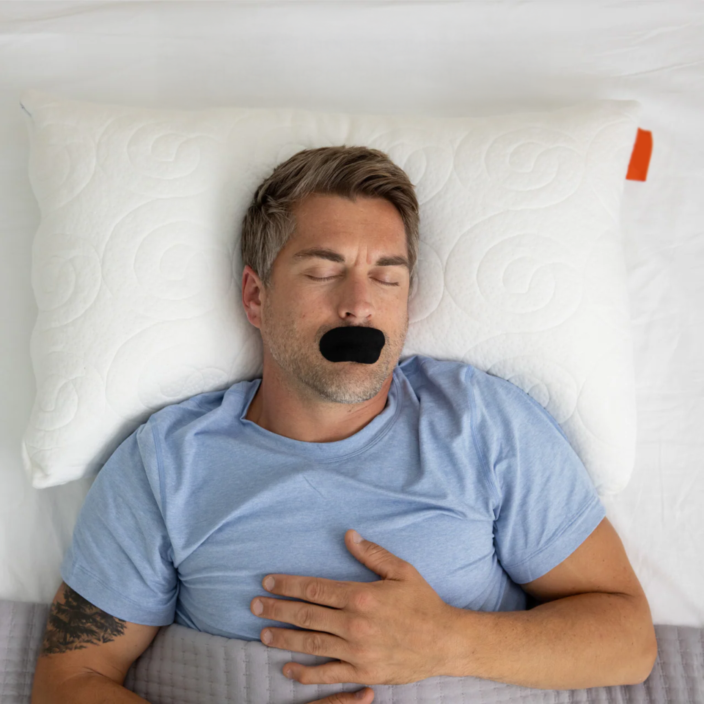 a man sleeping with mouth tape on